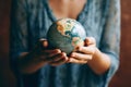 Woman's Hands Holding Earth Globe Model. Generative ai Royalty Free Stock Photo