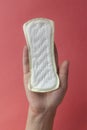 Woman`s hands holding a feminine hygiene pad. Hands of female hold menstrual pads or sanitary napkins for women Royalty Free Stock Photo