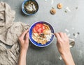 Woman`s hands holding honey drizzlier and blue healthy breakfast bowl Royalty Free Stock Photo