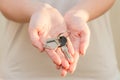 Woman's hands holding key with keychain in shape of the house Royalty Free Stock Photo