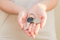 Woman's hands holding key with keychain in shape of the house Royalty Free Stock Photo