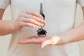 Woman's hands holding key with keychain in shape of the house Royalty Free Stock Photo