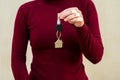 Woman's hands holding key with keychain in shape of the house Royalty Free Stock Photo