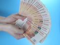 Woman`s hands holding many Russian ruble five thousand banknotes, side view Royalty Free Stock Photo