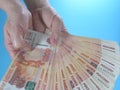 Woman`s hands holding many Russian ruble five thousand banknotes, side view Royalty Free Stock Photo