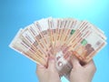 Woman`s hands holding many Russian ruble five thousand banknotes, side view Royalty Free Stock Photo