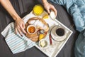 Woman`s hands holding a milk on the bed with white tray. Breakfast with coffee, croissants Royalty Free Stock Photo