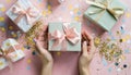 Woman\'s hands holding one gift or one present box decorated confetti on pink Royalty Free Stock Photo