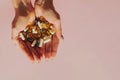 Woman`s hands holding various pills or diet supplements. Natural sunlight