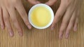 Woman`s hands holding white cup of chinese tea bamboo background, top view. A woman holding a cup of tea. Green japanese Royalty Free Stock Photo