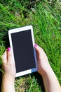 Woman`s hands holding white tablet with blank skreen