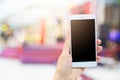 Woman`s hands holds modern electronic gadget. Unrecognizable female with white mobile phone and blank black screen for your advert