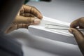 Woman`s hands inspecting rough diamonds with forceps. Royalty Free Stock Photo