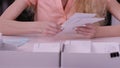 Woman`s hands iterate over the letters in envelopes. Close up of envelopes being in hands of an aged woman. Secretary