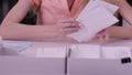 Woman`s hands iterate over the letters in envelopes. Close up of envelopes being in hands of an aged woman. Secretary