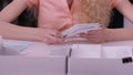 Woman`s hands iterate over the letters in envelopes. Close up of envelopes being in hands of an aged woman. Secretary