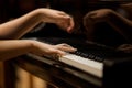 Woman's hands on the keyboard of the piano closeup