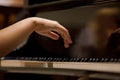 Woman's hands on the keyboard of the piano closeup