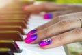 Woman`s hands on the keyboard of the piano closeup. Hands musician playing the piano. Top view. Hands pianist playing music on