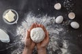 Woman's hands knead dough on table with flour Royalty Free Stock Photo