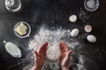 Woman's hands knead dough on table with flour Royalty Free Stock Photo