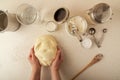 Woman`s hands kneading dough on kitchen table, top view Royalty Free Stock Photo