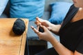 Woman`s hands knitting crochet relaxing at cafe.