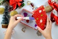 Woman's hands making a pregnancy test as a Christmas gift. table with decorations. View from above. Holiday mood, motherhood Royalty Free Stock Photo