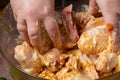 woman's hands marinate chicken wings in soy sauce, cream and garlic