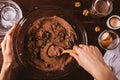 Woman's hands mixing melted chocolate and cocoa powder Royalty Free Stock Photo