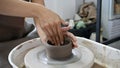 Woman`s hands moulding clay, making a clay pottery pot in the handicraft workshop Royalty Free Stock Photo