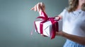 A woman`s hands open a gift box on a blue background. Valentine`s day, birthday concept Royalty Free Stock Photo