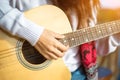 Woman`s hands playing acoustic guitar, close up Royalty Free Stock Photo