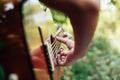 Woman`s hands playing acoustic guitar have fun outdoor, close up Royalty Free Stock Photo