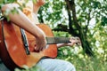 Woman`s hands playing acoustic guitar have fun outdoor, close up Royalty Free Stock Photo