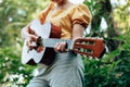 Woman`s hands playing acoustic guitar have fun outdoor, close up Royalty Free Stock Photo