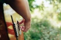 Woman`s hands playing acoustic guitar have fun outdoor, close up Royalty Free Stock Photo