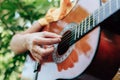 Woman`s hands playing acoustic guitar have fun outdoor, close up Royalty Free Stock Photo