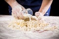 Woman`s hands pour the milk to dough for kneading Royalty Free Stock Photo