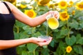 Woman's hands pours sunflower oil from the jar Royalty Free Stock Photo