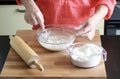 Woman's hands preparing fresh dough.