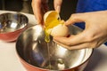 Woman`s hands separating egg