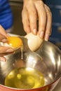 Woman`s hands separating egg