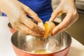 Woman`s hands separating egg