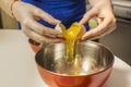 Woman`s hands separating egg