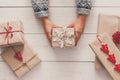 Woman`s hands show christmas holiday present with craft twine Royalty Free Stock Photo