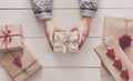 Woman`s hands show christmas holiday present with craft twine Royalty Free Stock Photo