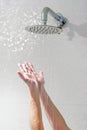 Female hands of a caucasian woman under a wall shower Royalty Free Stock Photo