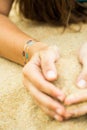 Woman's hands with sticker tatoo in the sand