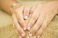 Woman's hands with sticker tatoo in the sand